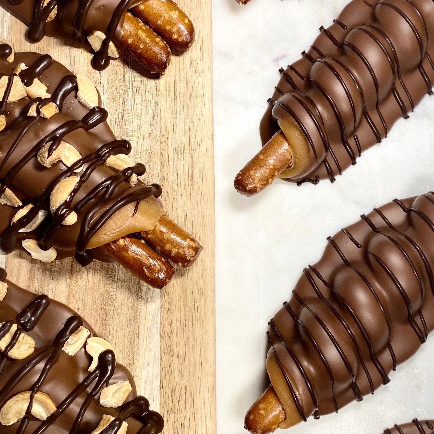 Chocolate-dipped pretzels with nuts on a wooden and marble surface